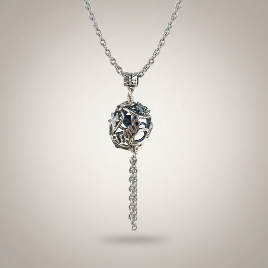 Bedrock Rose silver vine pendant necklace with grape clusters and leaves, featuring a hollow orb and chain tassel.