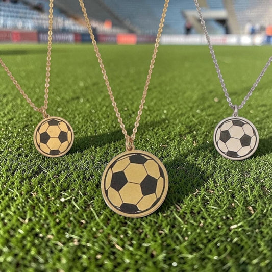 Bedrock Rose laser-engraved soccer ball pendant necklaces in brass and sterling silver on stainless steel chains.