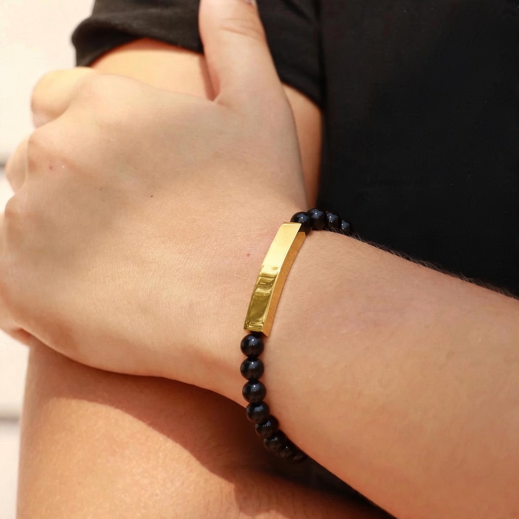 Bedrock Rose stretch bracelet with blue sodalite beads and a gold engravable curved bar on a wrist