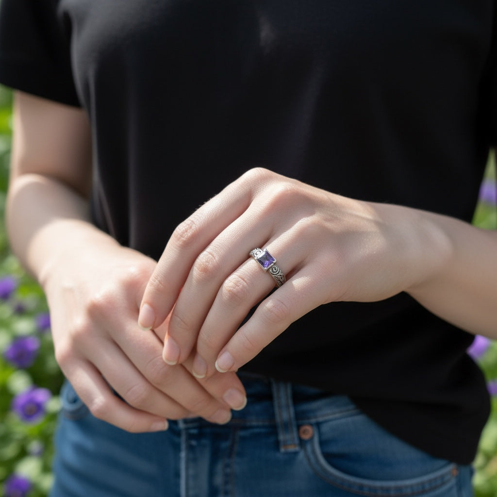 Bedrock Rose square amethyst nano gem ring with ornate sterling silver scrollwork band worn on a woman's finger