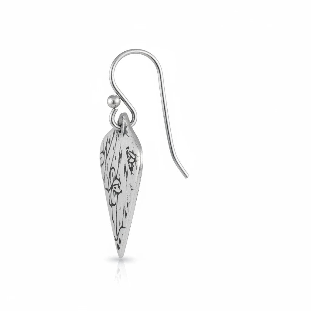Bedrock Rose sterling silver dangle earrings with oxidized patina, shield shape, and flowing botanical texture.