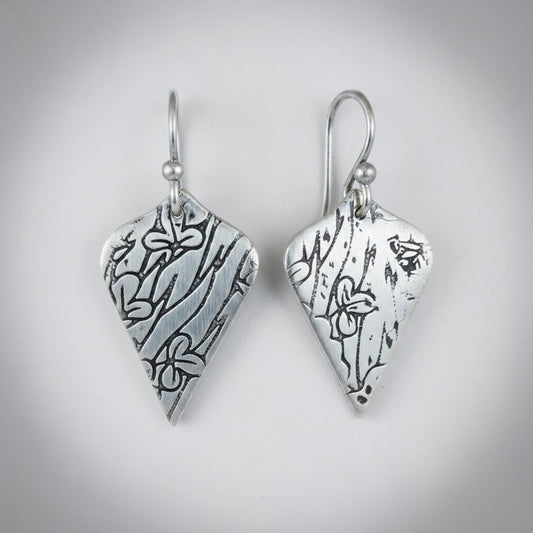 Bedrock Rose sterling silver shield dangle earrings with oxidized botanical texture and floral details.