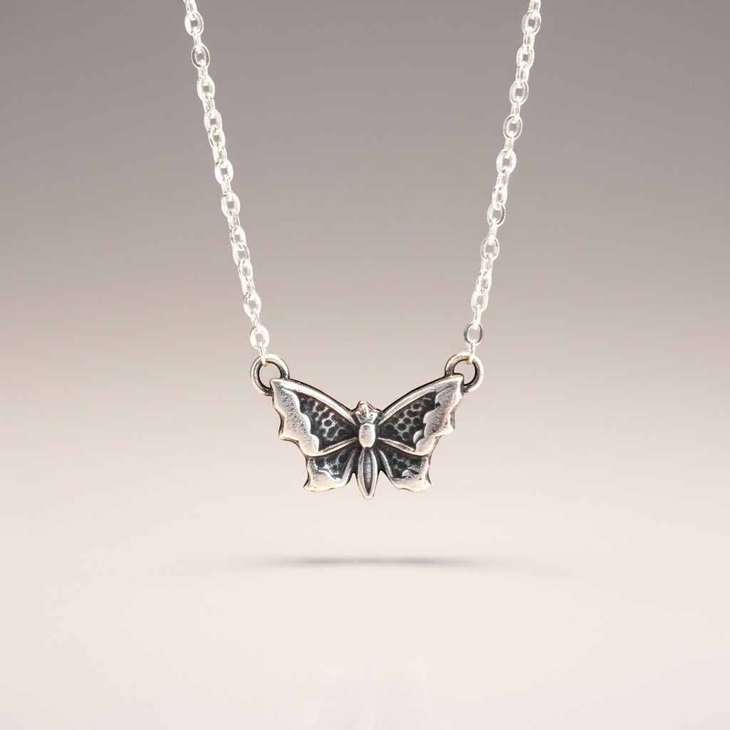 Bedrock Rose sterling silver butterfly pendant necklace with intricate wing detailing on a delicate chain.