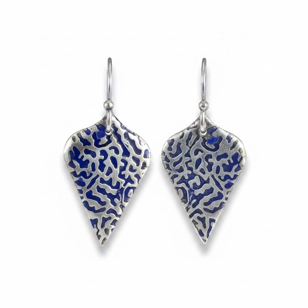 Bedrock Rose sterling silver shield earrings with organic blue coral texture, patina finish, and cobalt blue accents.