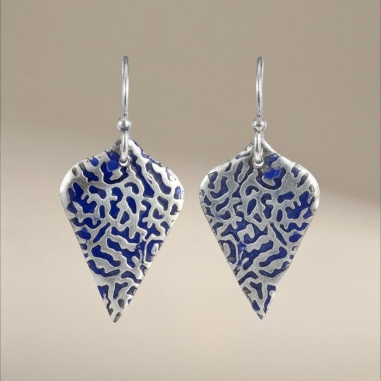 Bedrock Rose sterling silver shield earrings with organic blue coral texture and patina finish.
