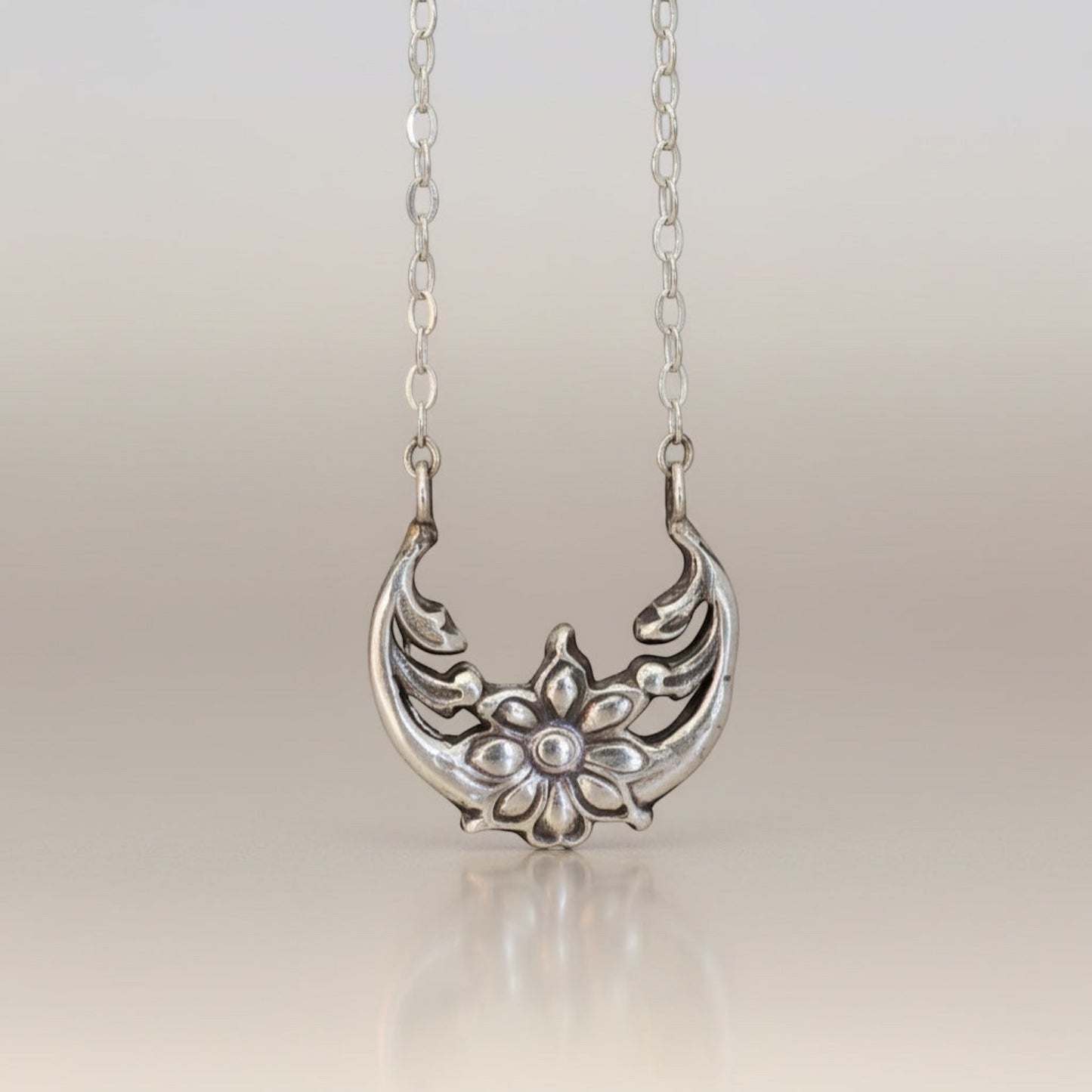 Bedrock Rose sterling silver floral crescent pendant necklace with moonflower motif, inspired by solar eclipse.