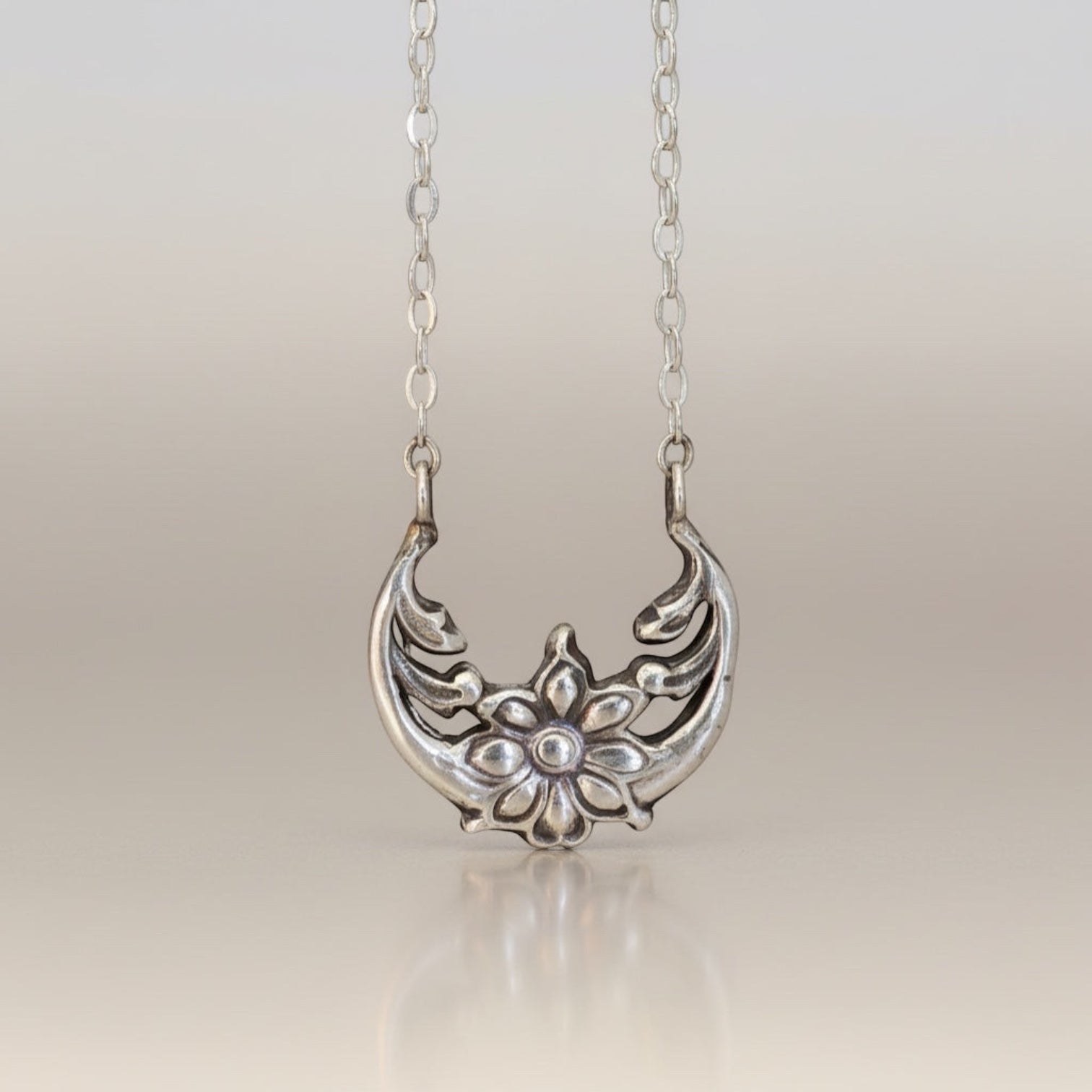 Bedrock Rose sterling silver floral crescent pendant necklace with moonflower motif, inspired by solar eclipse.