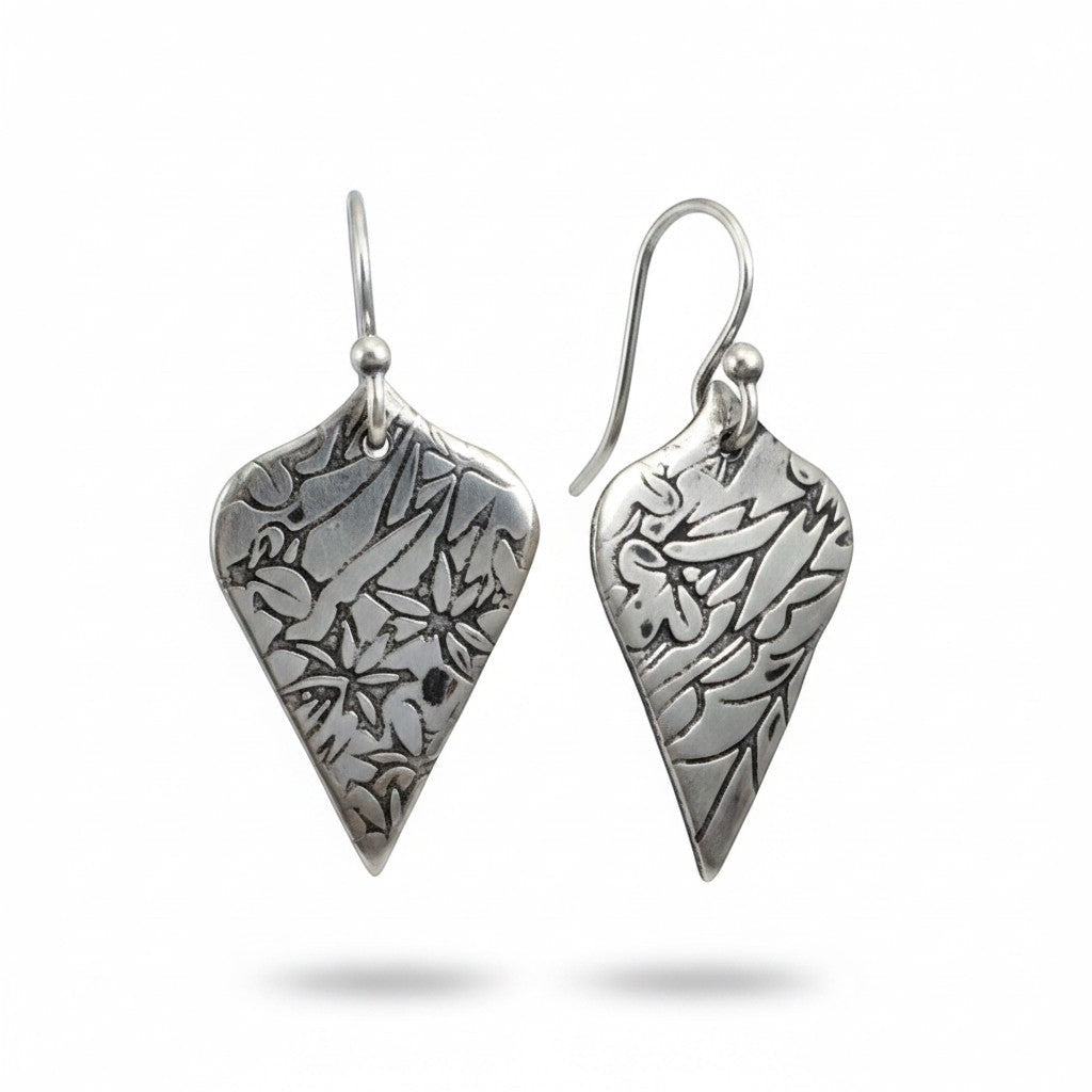 Bedrock Rose sterling silver shield dangle earrings with oxidized floral vine texture and botanical illustration style.