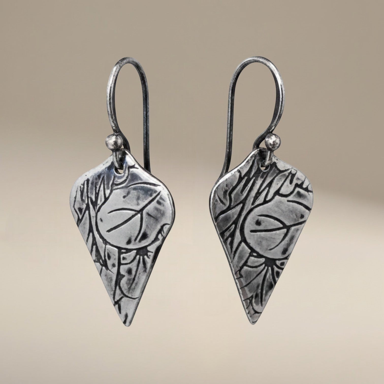 Bedrock Rose sterling silver dangle earrings with shield shape, lotus texture, and dark oxidized patina finish.