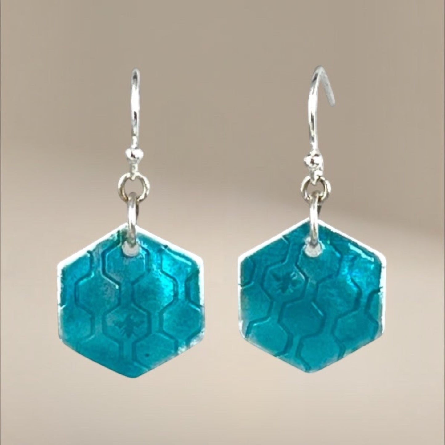 Bedrock Rose turquoise green hexagon dangling earrings with honeycomb pattern and bee detail.