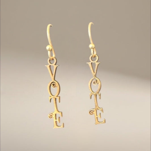 Bedrock Rose gold-tone dangle earrings with "VOTE" script and decorative scrolls. Laser-cut statement jewelry.