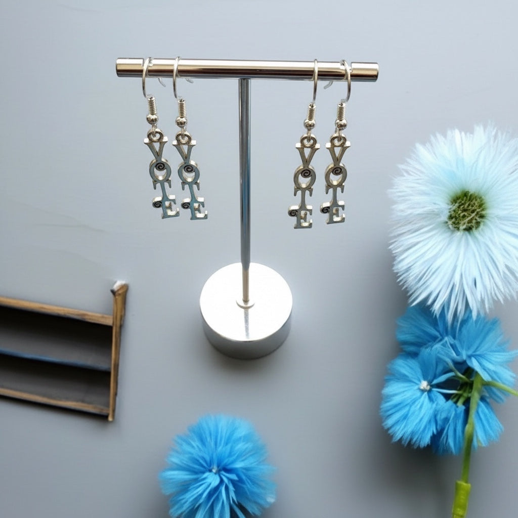 Bedrock Rose sterling silver dangling earrings featuring the word "Vote" in a scroll font. Two pairs shown, one smaller than the other.