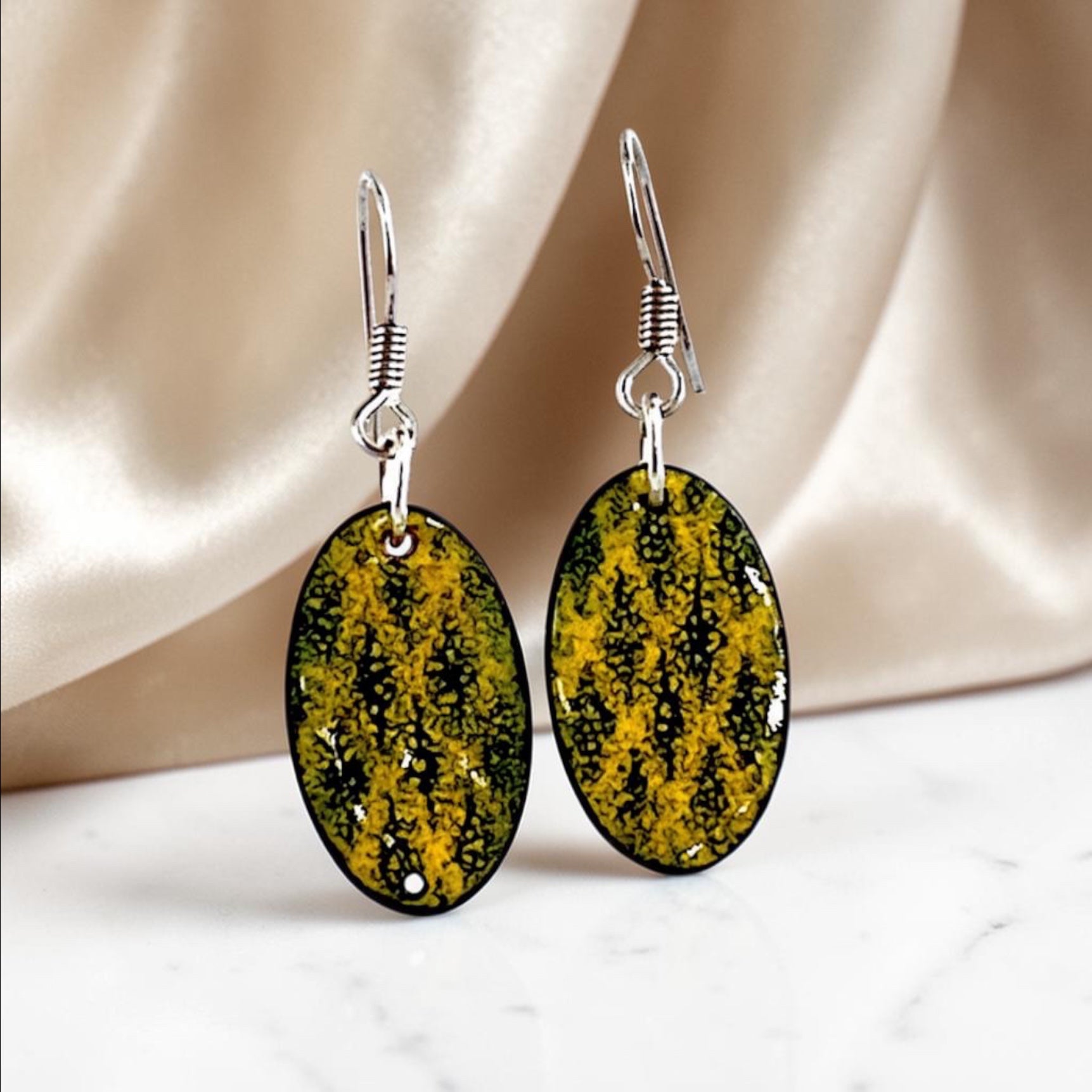 Bedrock Rose yellow and black oval dangling earrings with black diamond accents.