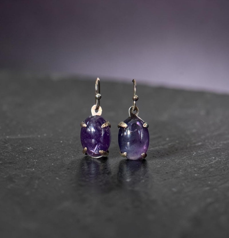 Bedrock Rose oval amethyst prong set dangle earrings with silver hooks.