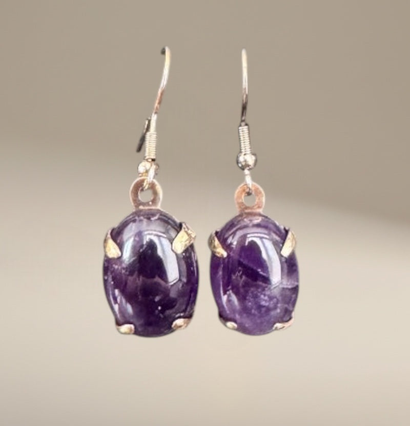 Bedrock Rose oval amethyst prong set dangle earrings with silver hooks.