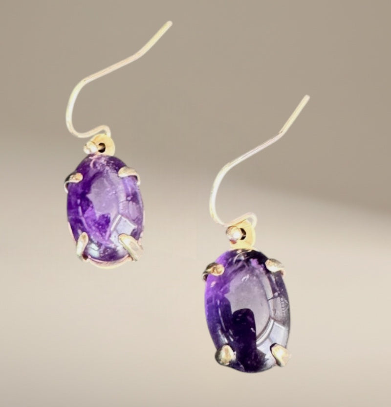 Bedrock Rose oval amethyst prong set dangle earrings with silver hooks.