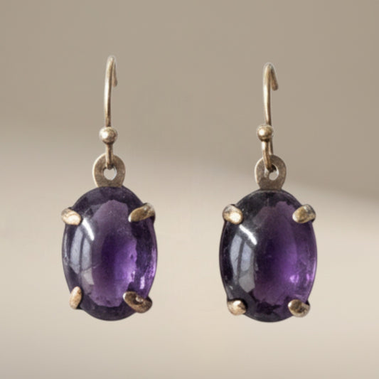 Bedrock Rose oval amethyst prong set dangle earrings with gold hooks.
