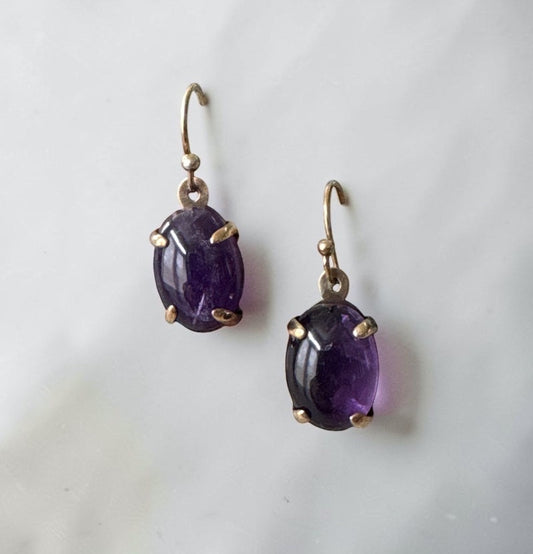 Bedrock Rose oval amethyst prong set dangle earrings with gold hooks.