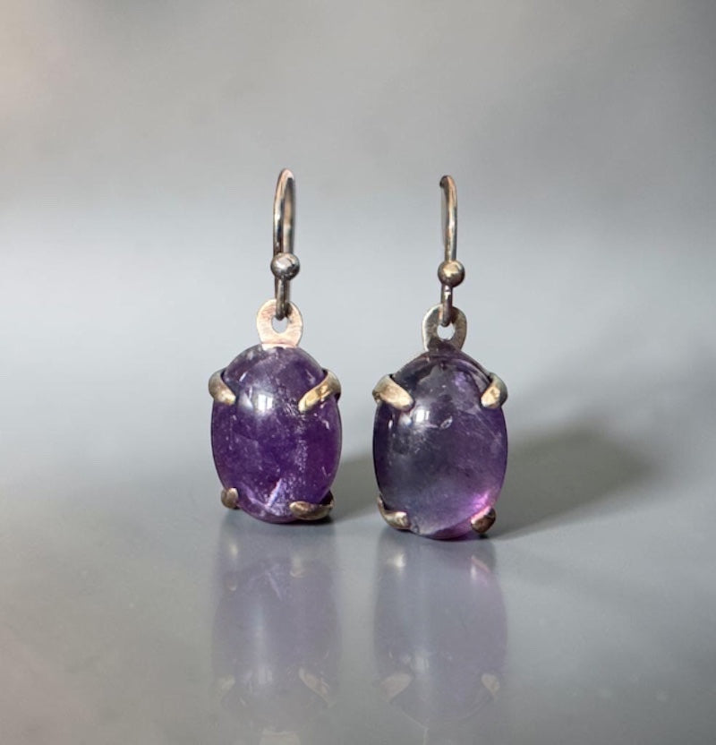 Bedrock Rose oval amethyst prong set dangle earrings with silver hooks.
