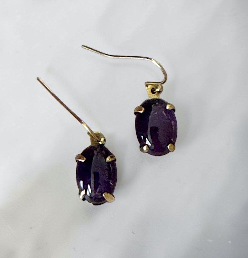 Bedrock Rose oval amethyst prong set dangle earrings with gold-tone hooks.