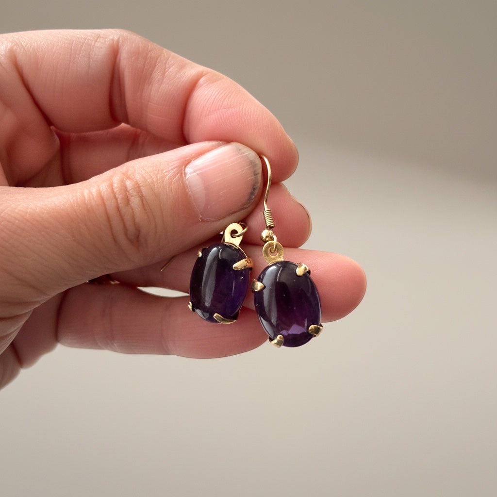 Bedrock Rose amethyst prong set oval drop earrings with gold-tone hooks.