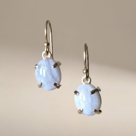 Bedrock Rose blue lace agate oval prong set dangle earrings with gold hooks.