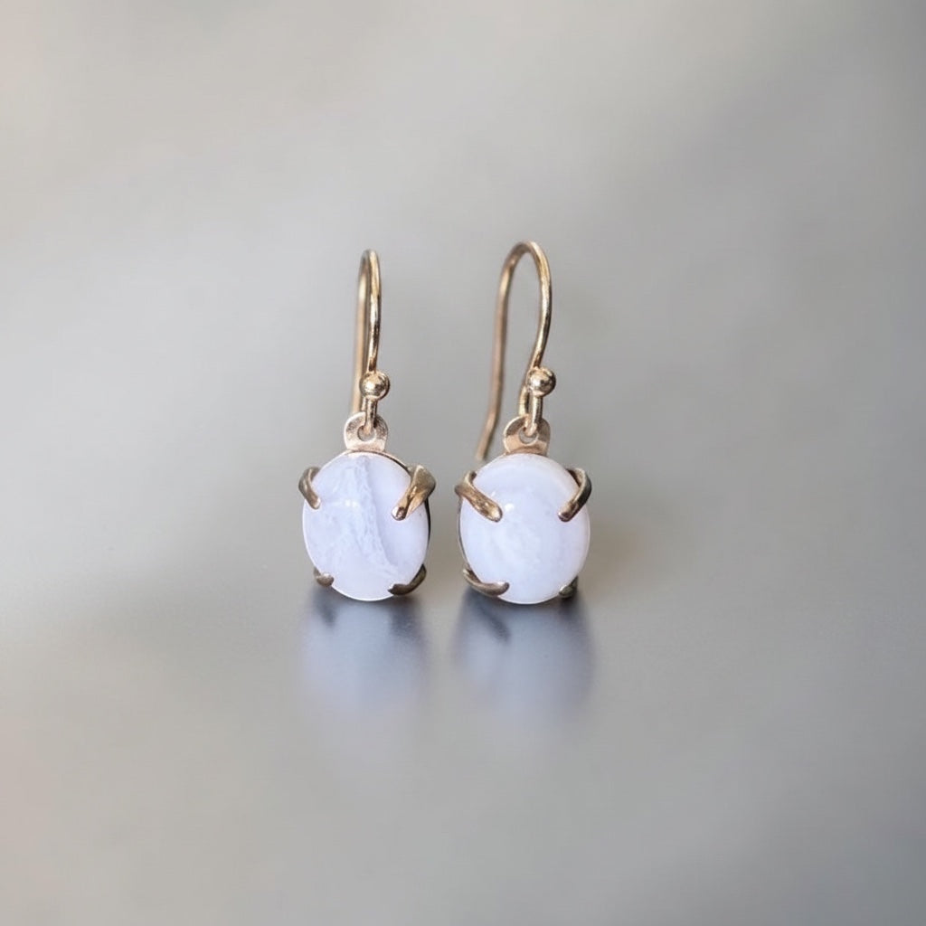 Bedrock Rose blue lace agate oval prong set dangle earrings with gold-tone hooks.