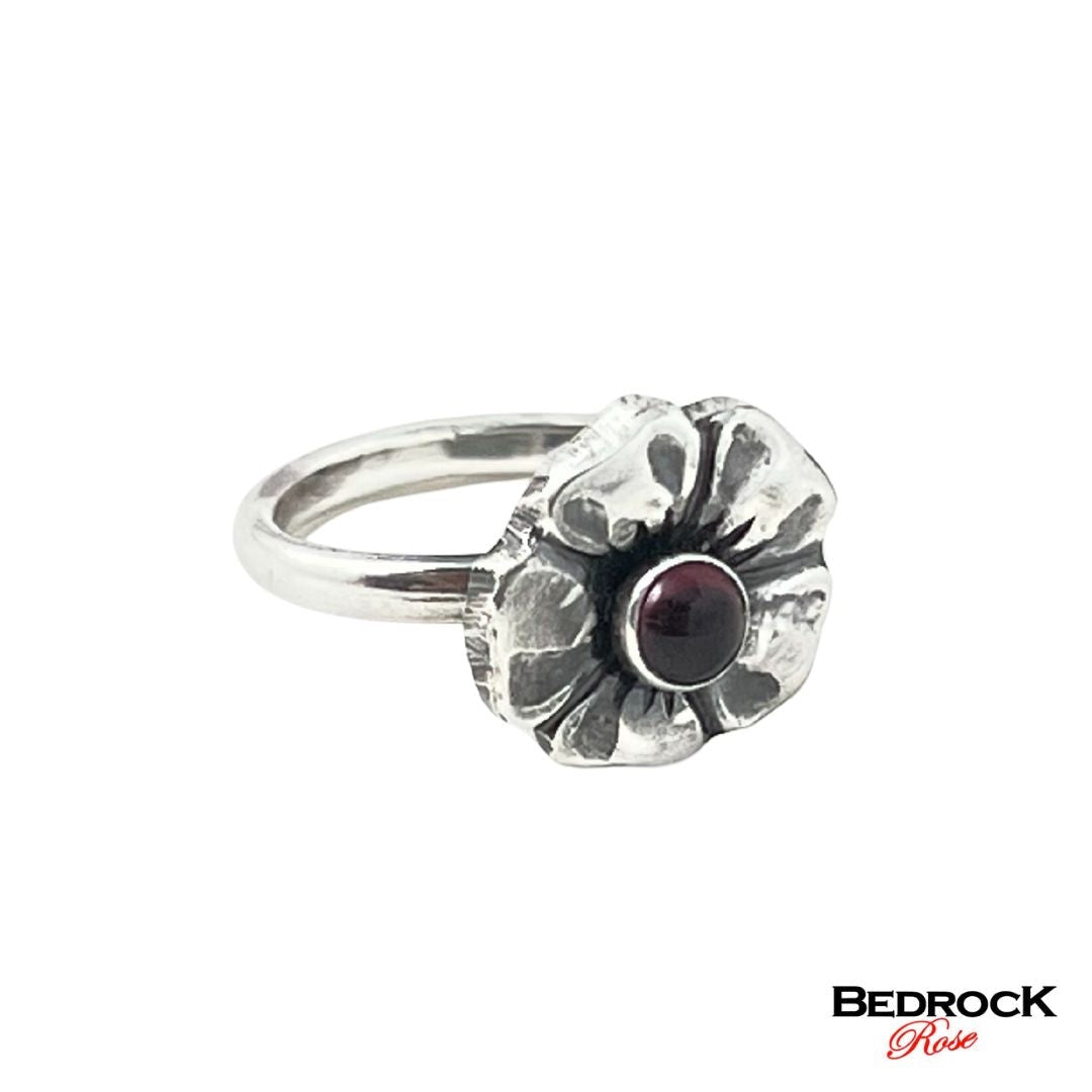 Bedrock Rose sterling silver ring with a garnet gemstone set in a detailed cherry blossom design. Size 6.25.