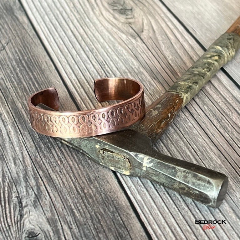 Bedrock Rose copper cuff bracelet with an ombre finish and infinity pattern. Antiqued and high shine details.