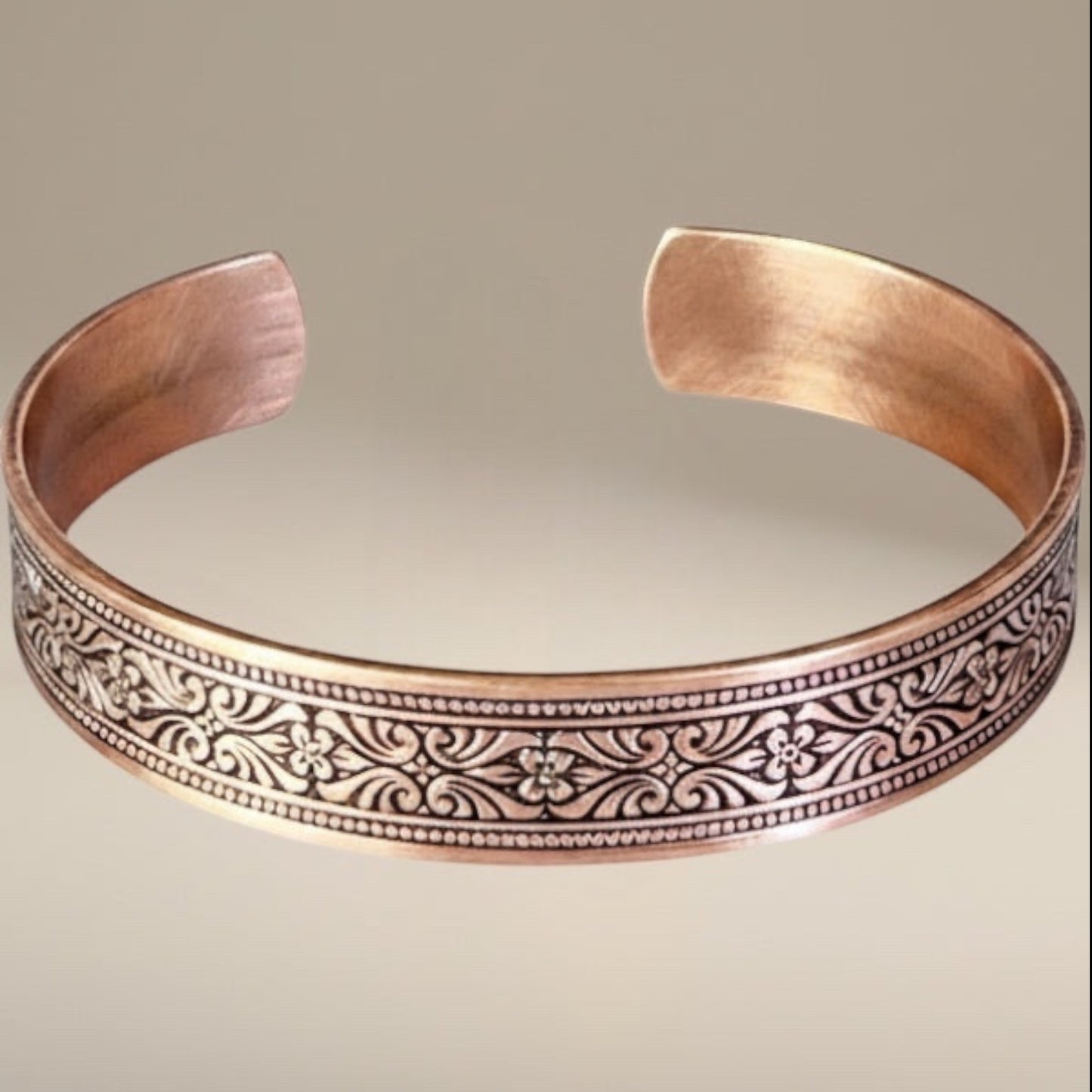 Bedrock Rose copper cuff bracelet with intricate scrollwork and floral engraving. Polished finish.