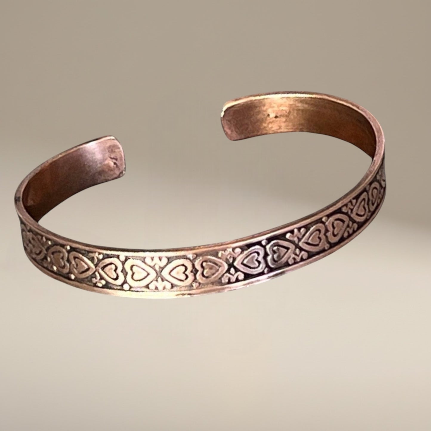 Bedrock Rose copper cuff bracelet with heart pattern design and antiqued finish.