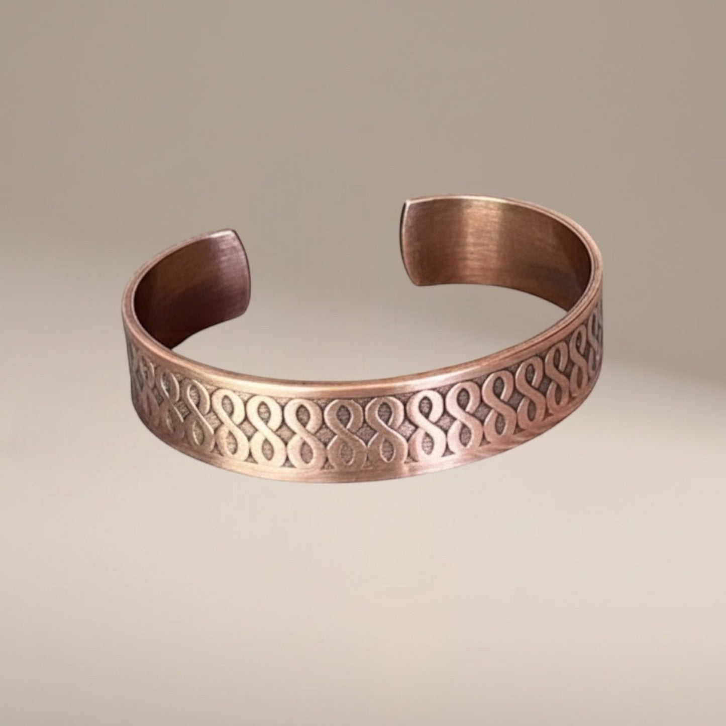 Bedrock Rose copper cuff bracelet with an ombre finish and infinity pattern. Antiqued and high shine details.