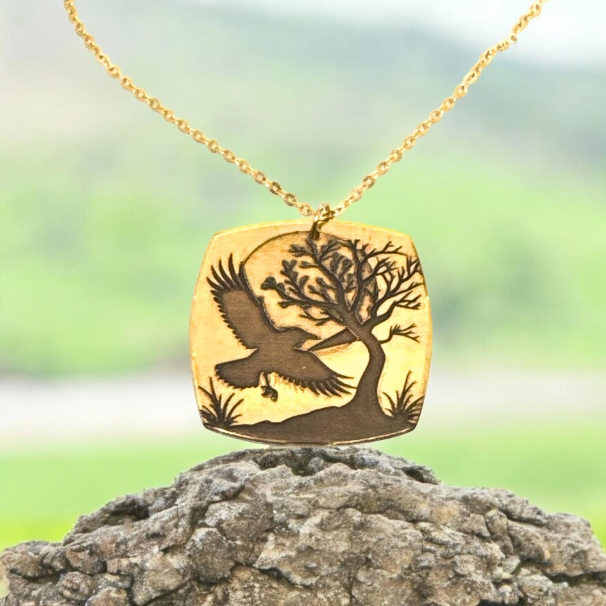 Bedrock Rose gold-plated brass necklace with laser-engraved crow, tree, and moon design. Hypoallergenic chain.