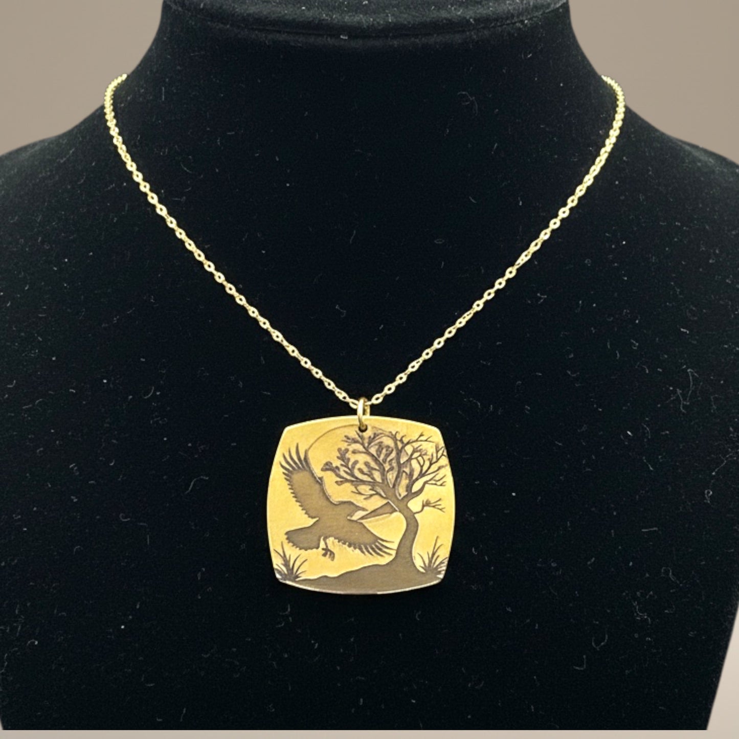 Bedrock Rose gold-plated brass necklace with laser-engraved crow, tree, and moon design. Hypoallergenic chain.