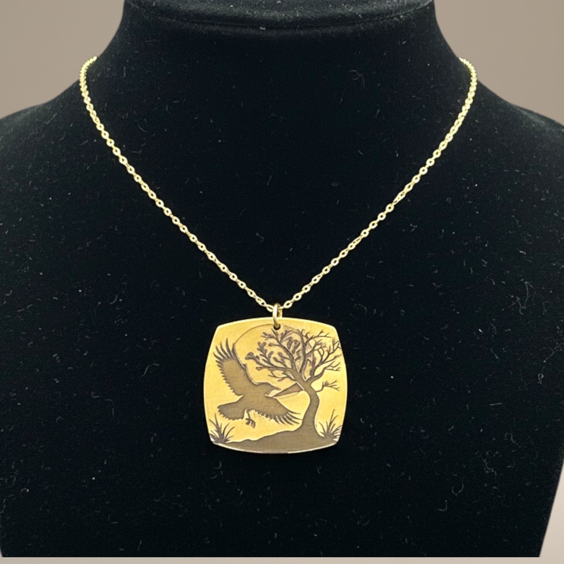 Bedrock Rose gold-plated brass necklace with laser-engraved crow, tree, and moon design. Hypoallergenic chain.
