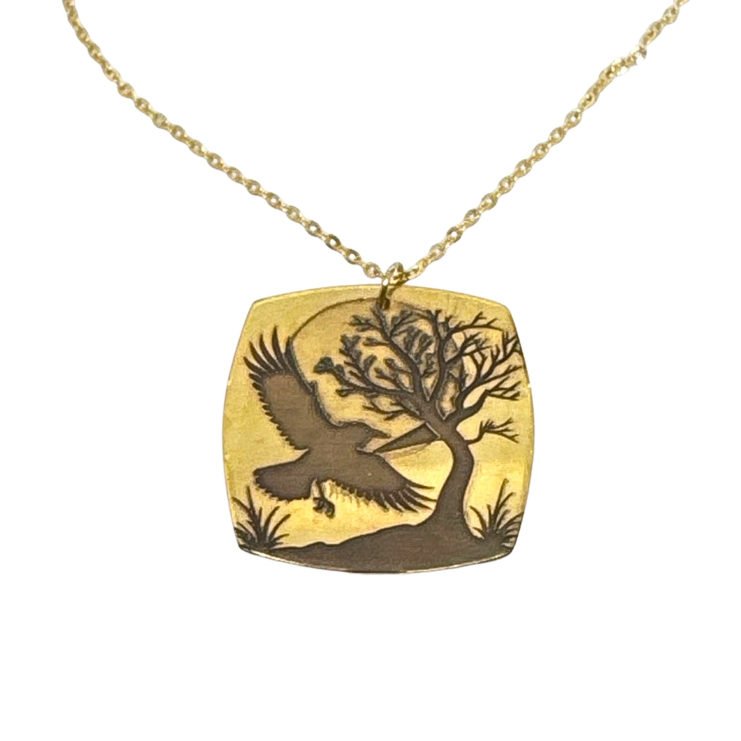 Bedrock Rose gold-plated brass necklace with laser-engraved crow, tree, and moon pendant on a gold stainless steel chain.
