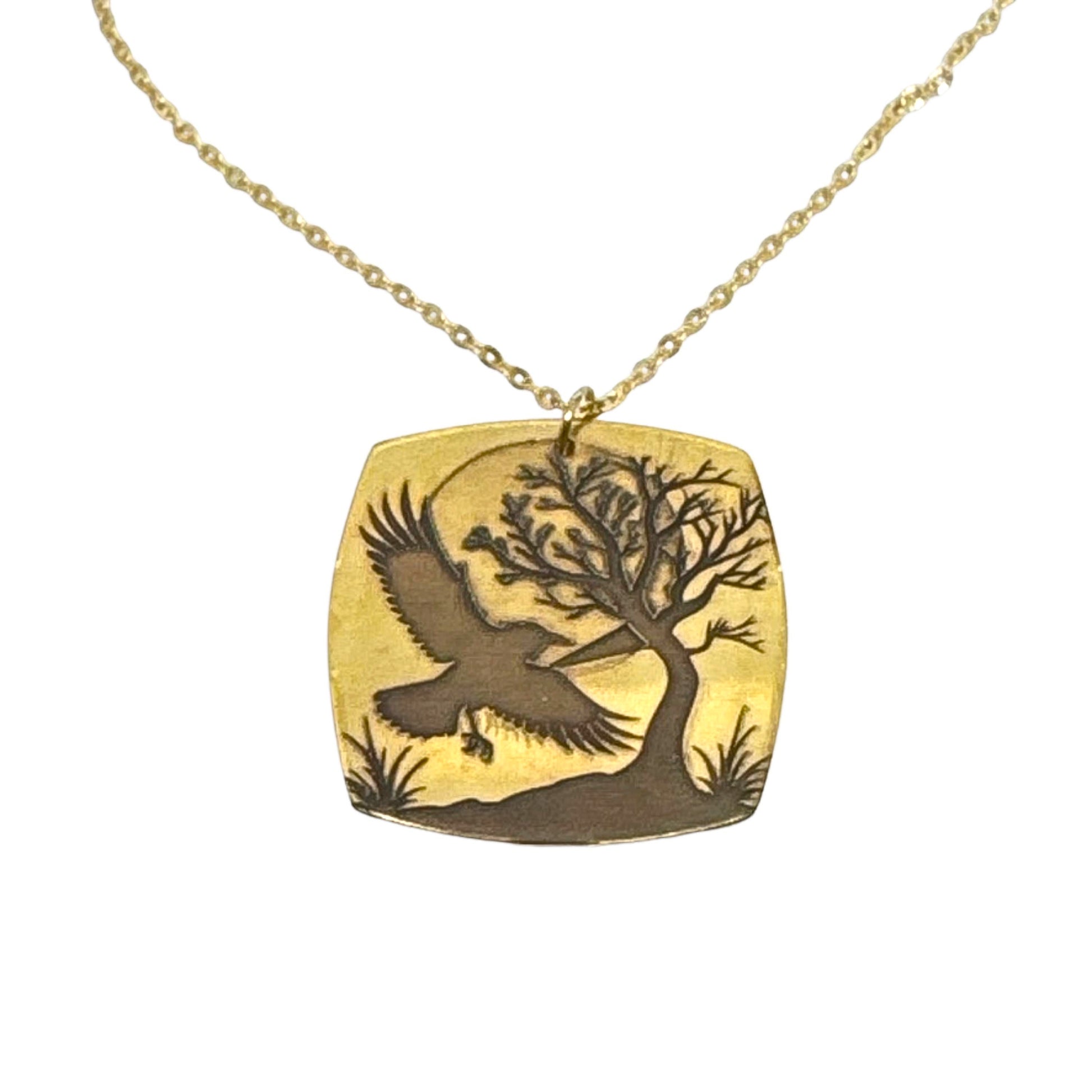 Bedrock Rose gold-plated brass necklace with laser-engraved crow, tree, and moon pendant on a gold stainless steel chain.
