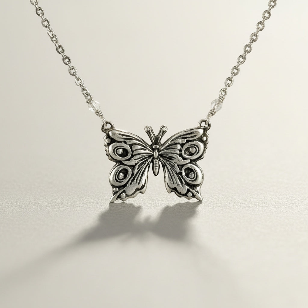Bedrock Rose fine silver butterfly pendant necklace with intricate details and delicate chain.