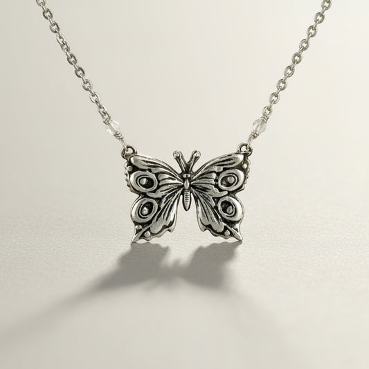 Bedrock Rose fine silver butterfly pendant necklace with intricate details and delicate chain.