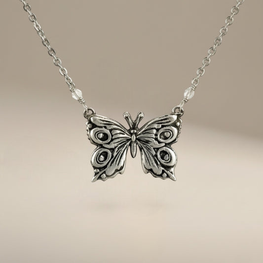 Bedrock Rose fine silver butterfly pendant necklace with intricate details and delicate chain.