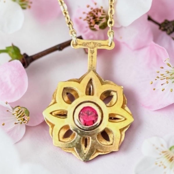 Bedrock Rose gold Art Deco floral pendant necklace with a central ruby, delicate chain.