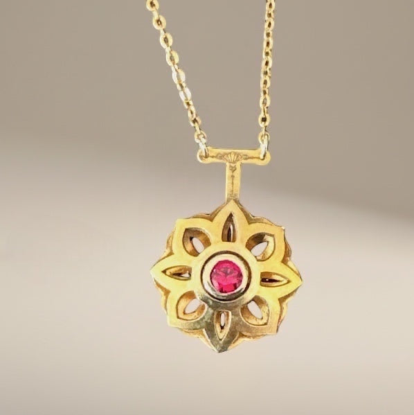 Bedrock Rose gold Art Deco floral pendant necklace with a central ruby. Intricate design, timeless elegance.