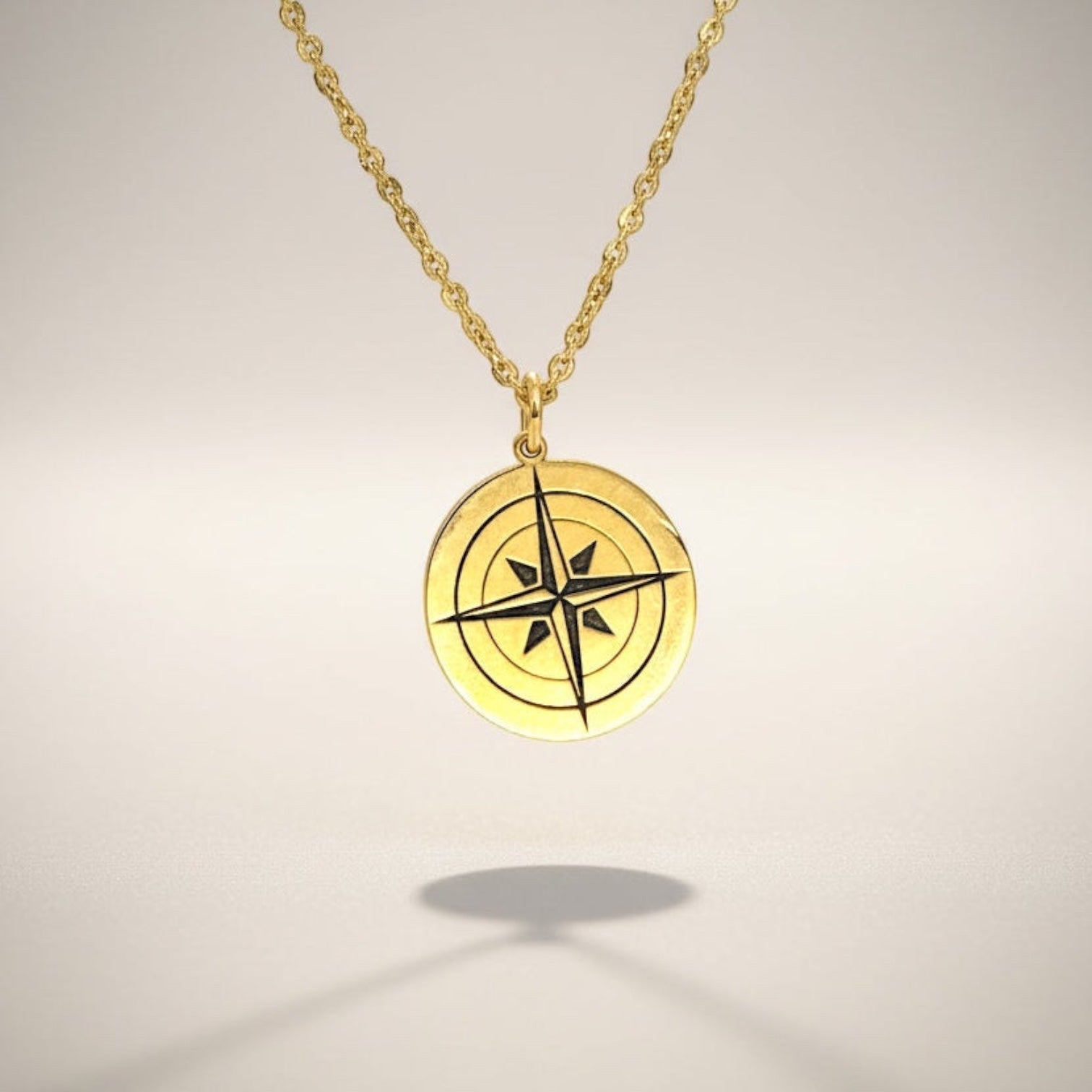 Bedrock Rose gold compass rose pendant necklace with a faceted chain. Symbol of purpose and self-discovery.