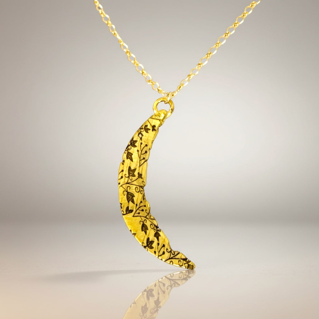Bedrock Rose gold crescent pendant necklace with intricate vine pattern and gold fill chain.