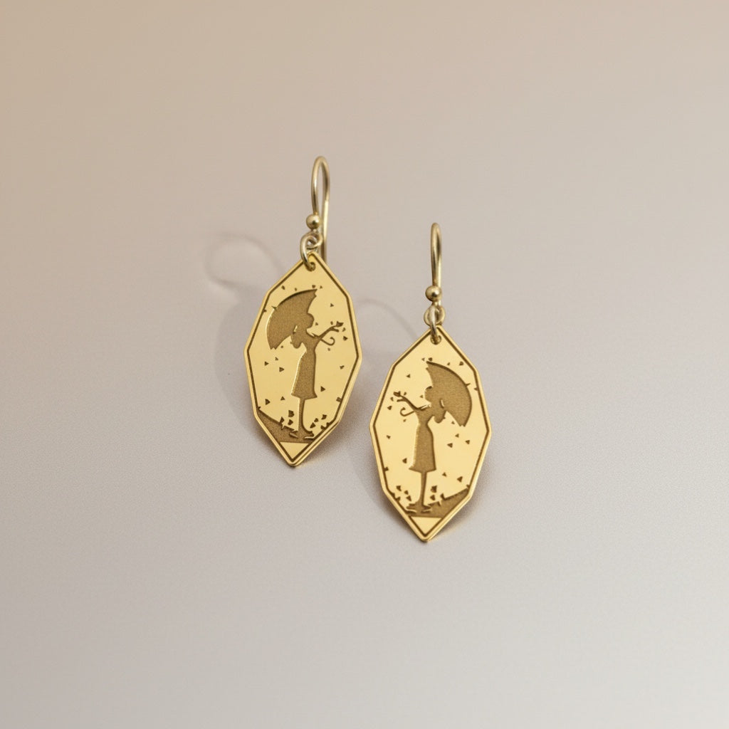 Bedrock Rose gold-plated earrings featuring a silhouette of a girl holding an umbrella, with falling leaves detail.