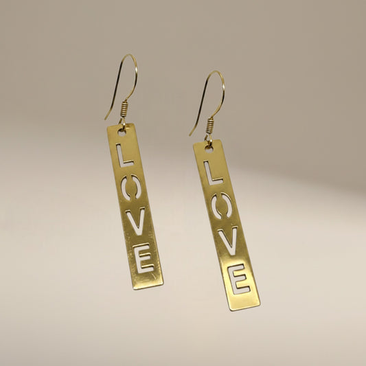 Bedrock Rose gold-plated dangling earrings with laser-cut 'LOVE' text. Surgical steel earwires.