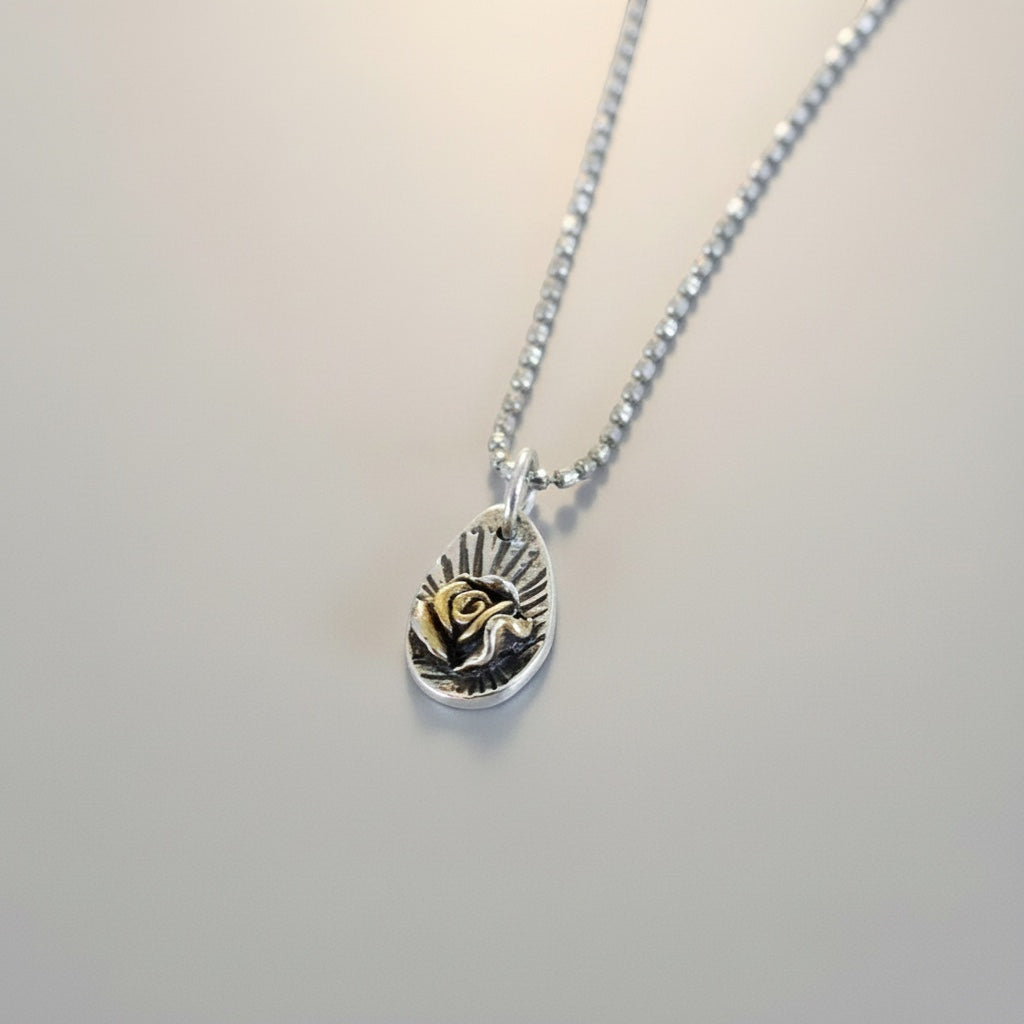 Bedrock Rose gold-plated Floribunda Rose pendant on a silver chain. Intricate rose detail.