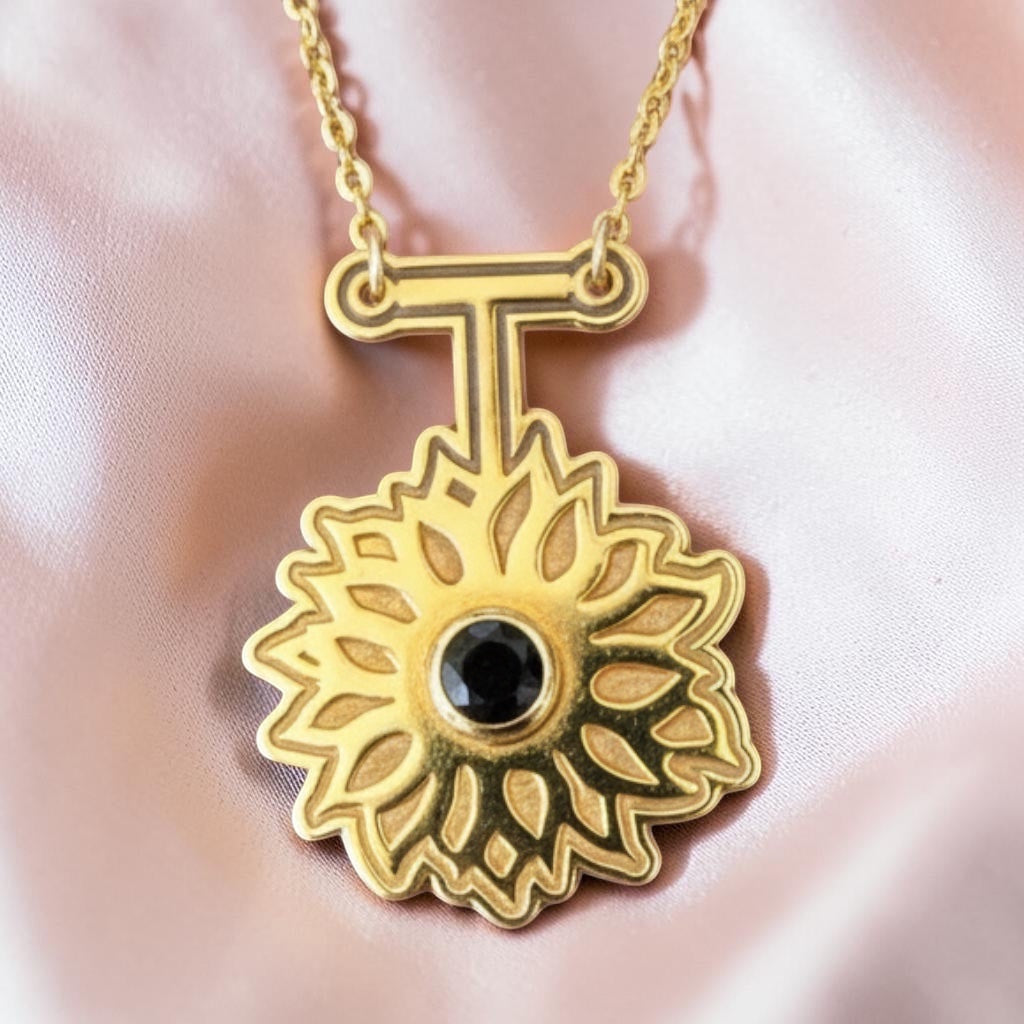 Bedrock Rose gold sunflower necklace with black obsidian pendant and gold chain.