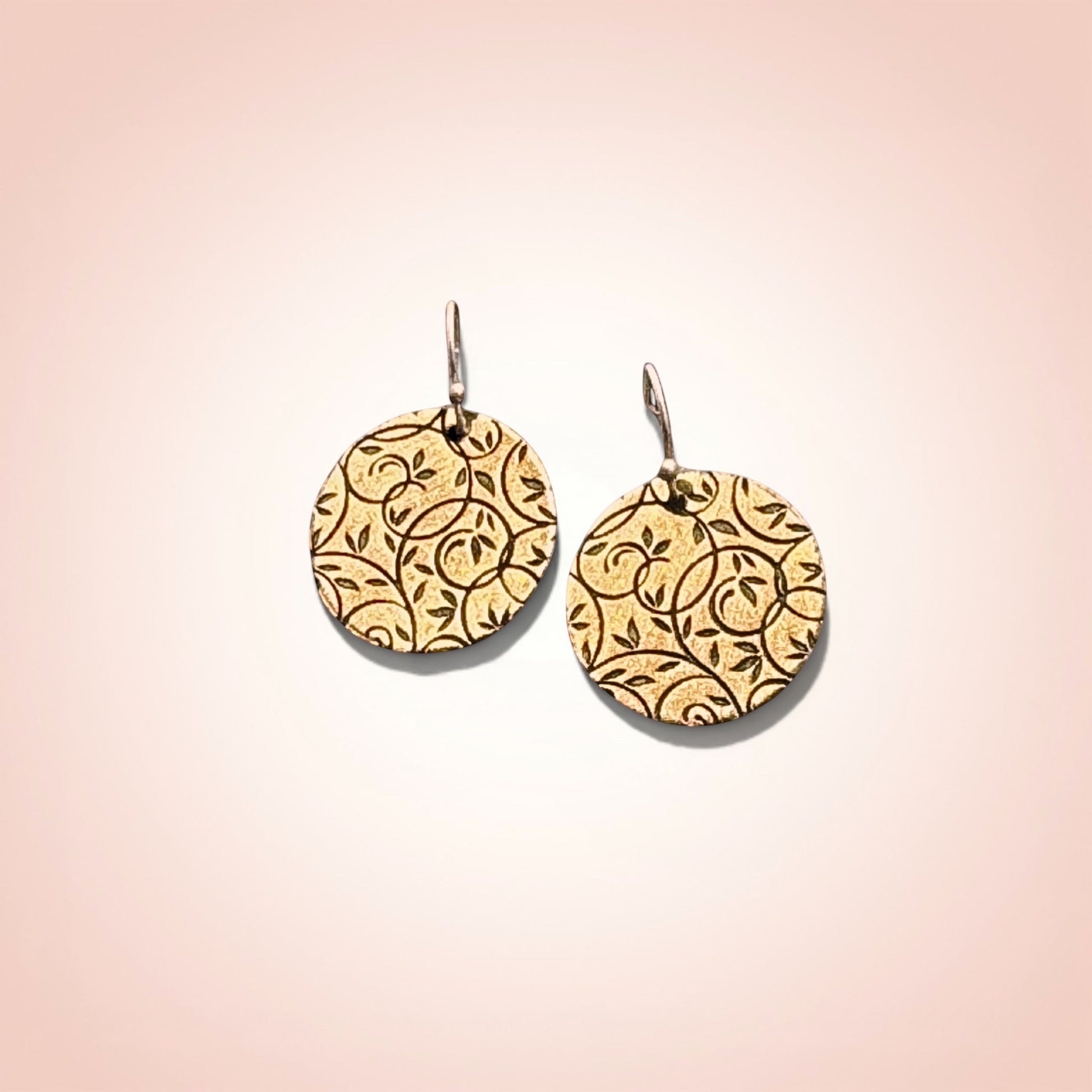 Bedrock Rose gold-tone disc earrings with all-over botanical vine lattice etching. Lightweight dangles.