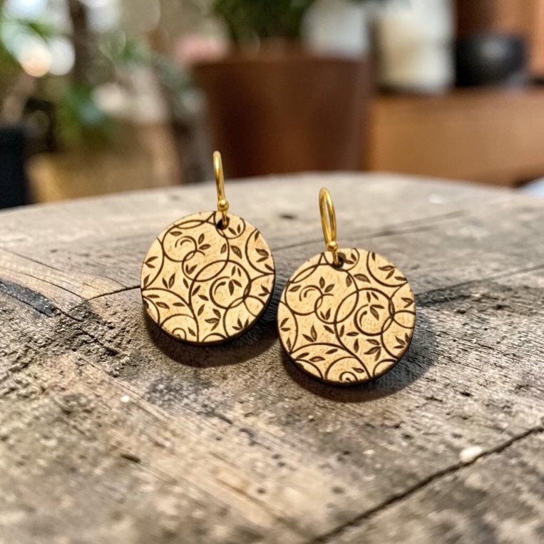 Bedrock Rose gold-tone disc earrings with all-over botanical vine lattice etching and gold hooks.